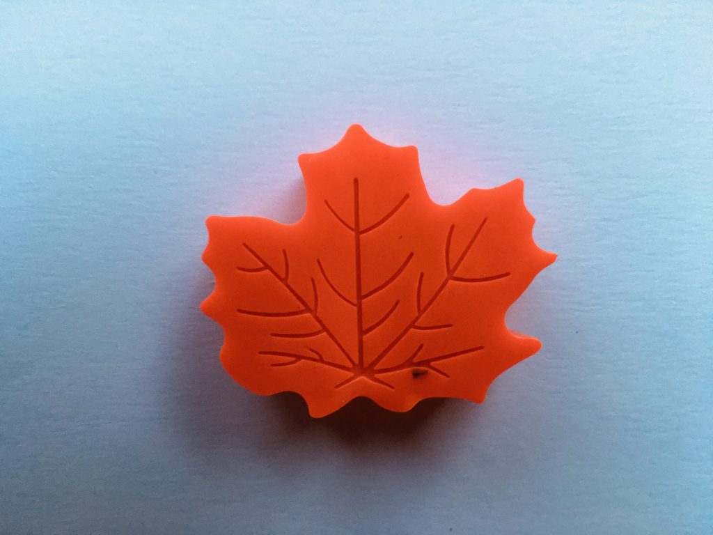 red leaf-shaped crayon